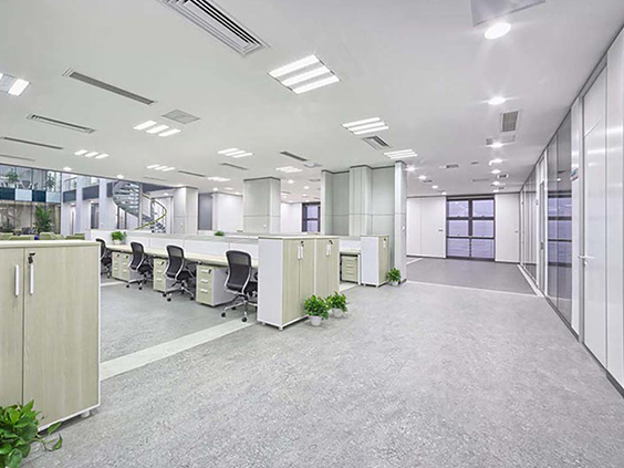 Spacious, well-lit office space with modern lighting fixtures and organized workstations, highlighting commercial electrical solutions